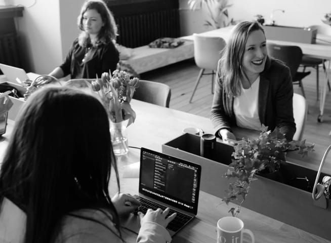 Three women working in an open office